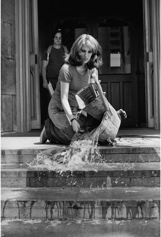 Mierle Laderman Ukeles Washing, Tracks, Maintenance: Outside, July 22, 1973,  Performance at the Wadsworth Atheneum, Hartford, CT. Black and white photograph, 20 x 16 in. Courtesy the artist and Ronald Feldman Fine Arts, New York